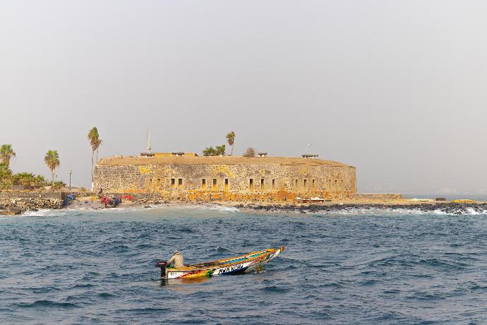 a small boat in the middle of a body of water